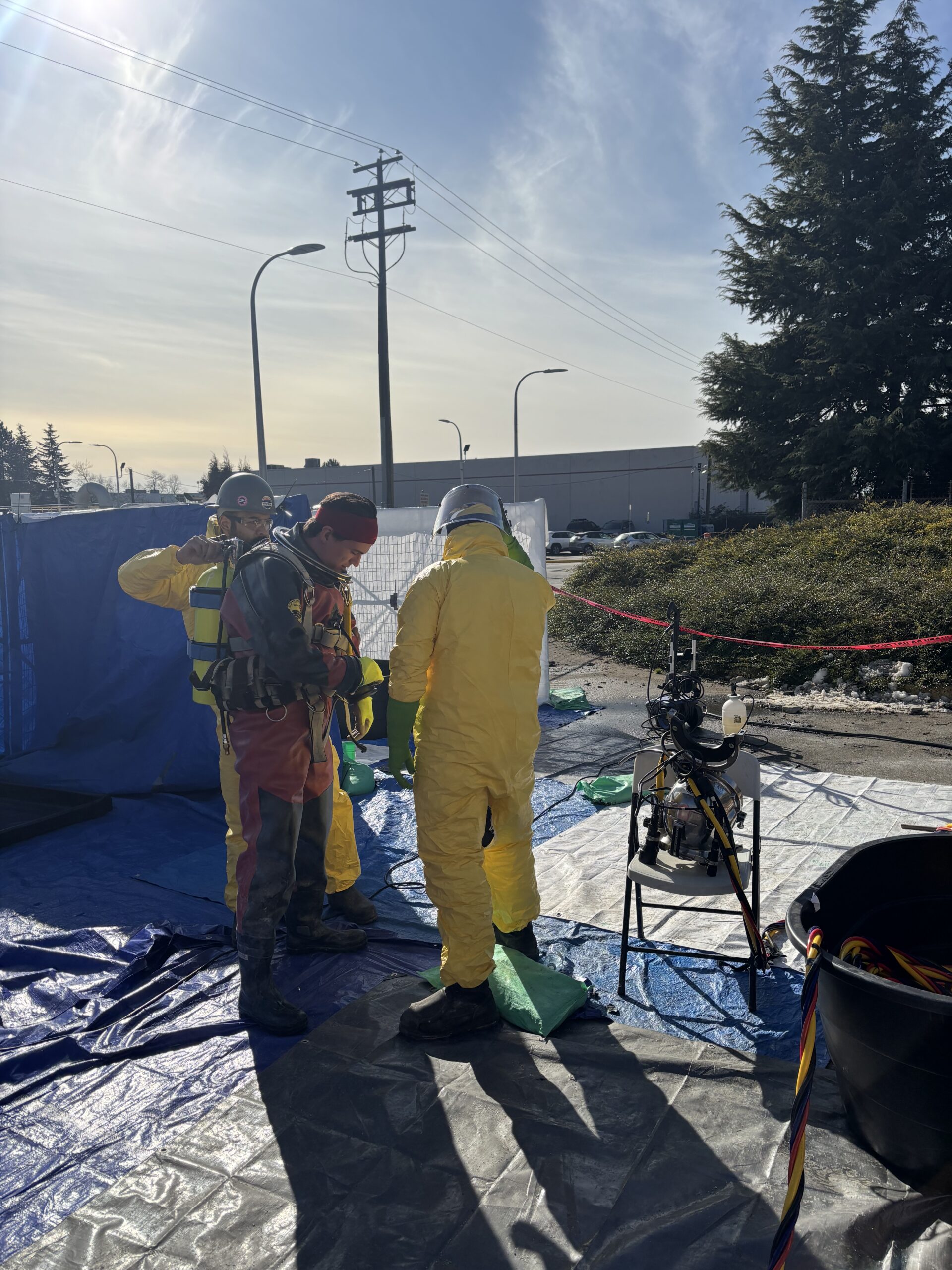 Commercial diver and decontamination team at a controlled boundary