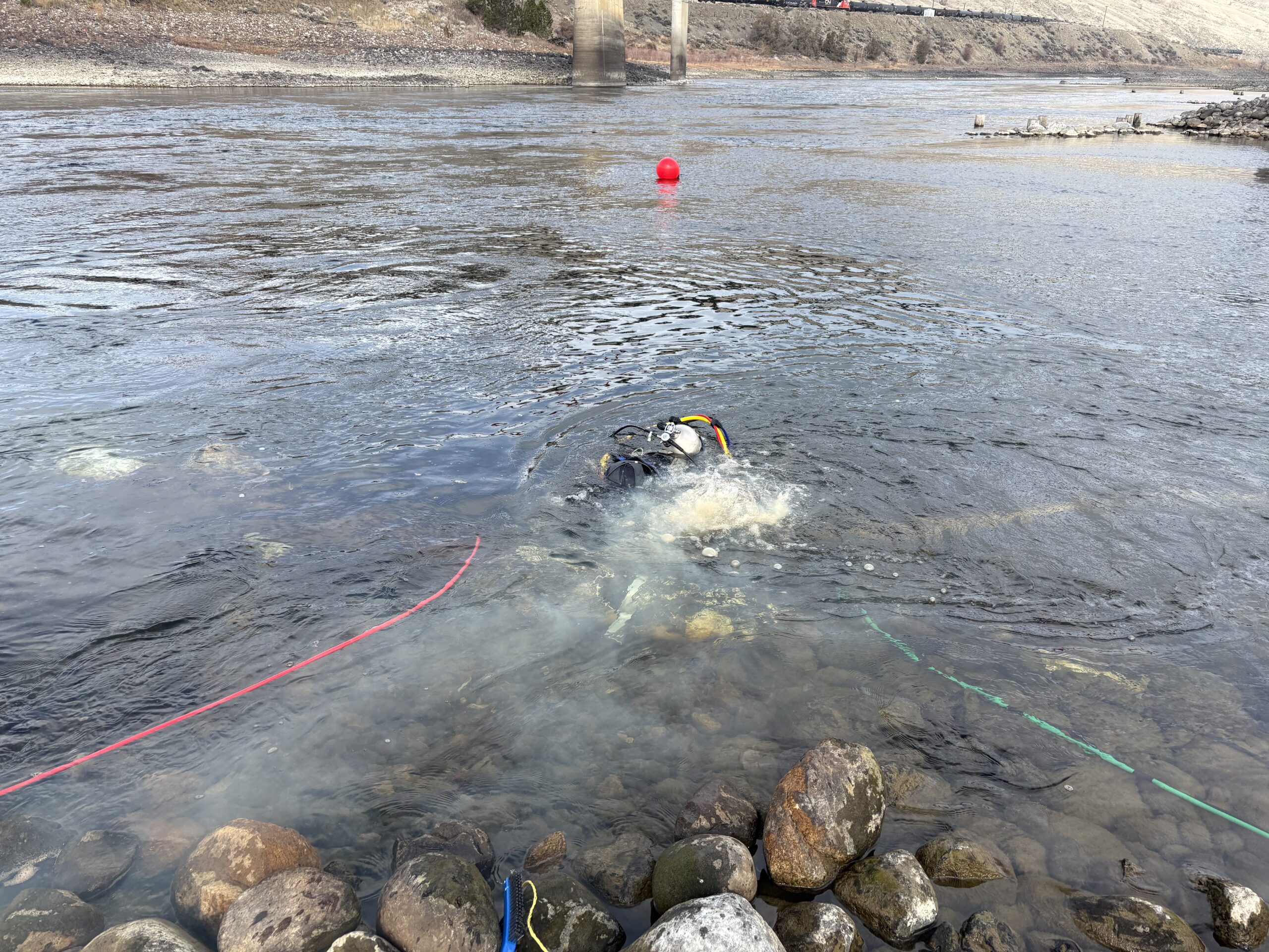 Commercial diver completing an underwater inspection at an industrial asset