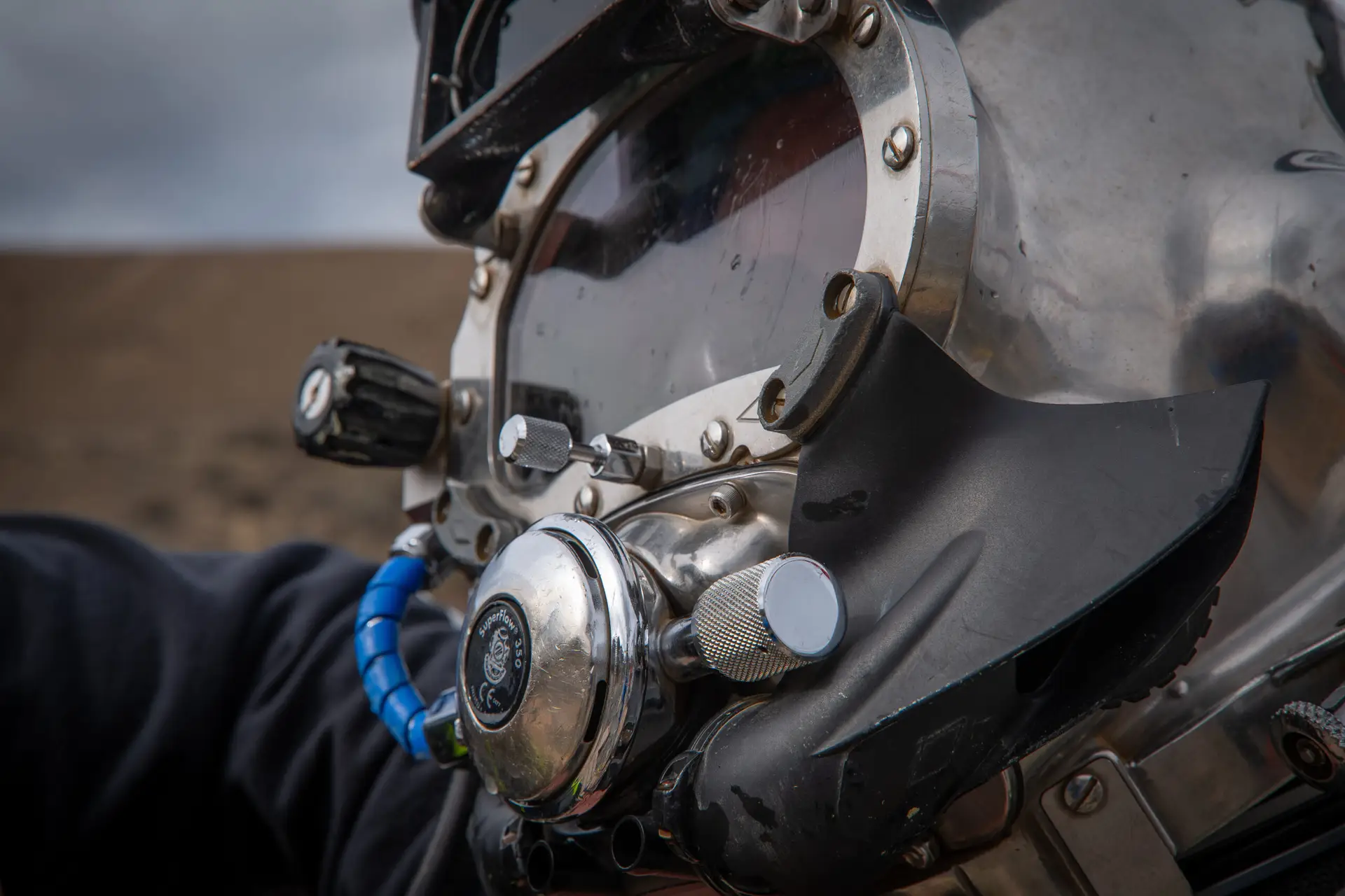 Commercial diver preparing submerged equipment for magnetic particle testing
