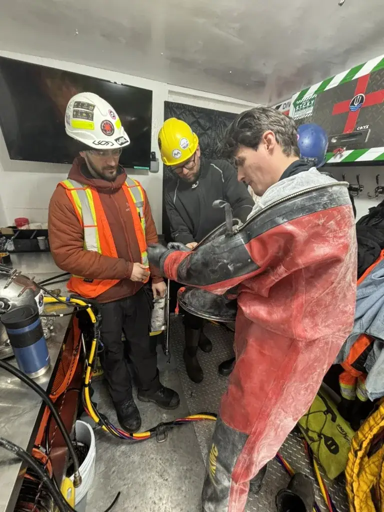 Contaminated Diving Services team preparing an encapsulated commercial diver